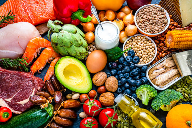 Colorful fresh whole foods including vegetables, proteins, grains and healthy fats